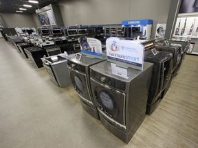 FILE - In this Thursday, July 20, 2017, file photo, the Kenmore Elite Smart Electric Dryer and Front Load Washer, center, appears on display at a Sears store, in West Jordan, Utah. On Thursday, July 27, 2017, the Commerce Department releases its report on durable goods for June. (AP Photo/Rick Bowmer, File)