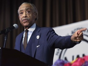 FILE - In this April 27, 2017 file photo, The Rev. Al Sharpton points to Omarosa Manigault, assistant to President Donald Trump & Director of Communications for the Office of Public Liaison, as he delivers his remarks during the Women's Power Luncheon of the 2017 National Action Network convention, in New York.  Sharpton is accusing President Trump of "encouraging police violence" during a speech this week on Long Island to an audience of uniformed officers. The activist preacher tore into Trump on Saturday, July 29 at the weekly gathering of his National Action Network in Harlem. (AP Photo/Richard Drew, File)