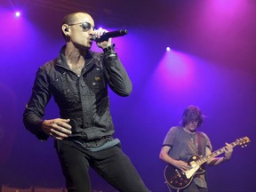 FILE - In this May 16, 2015 file photo, Chester Bennington, left, performs during the MMRBQ Music Festival 2015 at the Susquehanna Bank Center in Camden, N.J.  Talinda Bennington, wife of Chester Bennington  said in a statement Friday, July 28, 2017,  she wants "to let my community and the fans worldwide know that we feel your love. We feel your loss as well." Chester Bennington hanged himself from a bedroom door in his home near Los Angeles last week. His death was ruled a suicide. (Photo by Owen Sweeney/Invision/AP, File)