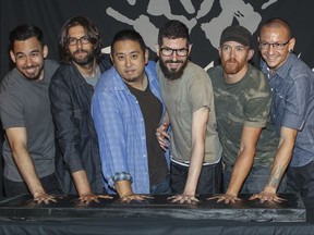 FILE - In this June 18, 2014 file photo, members of Linkin Park, from left, Mike Shinoda, Rob Bourdon, Joe Hahn, Brad Delson, Dave Farrell and Chester Bennington attend an induction ceremony for the Guitar Center's RockWalk at Guitar Center in Los Angeles. Linkin Park said their hearts are broken following the death of Bennington, who died by hanging last week. The rock band said Monday, July 24, 2017, the "shockwaves of grief and denial are still sweeping through our family as we come to grips with what has happened." (Photo by Paul A. Hebert/Invision/AP, File)