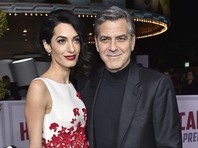 FILE - In this Feb. 1, 2016 file photo, Amal Clooney, left, and George Clooney arrive at the world premiere of "Hail, Caesar!" in Los Angeles. Clooney's foundation is planning to open seven public schools for Syrian refugee children. The Clooney Foundation for Justice announced a new partnership Monday, July 31, 2017, with Google, HP and UNICEF to provide education for more than 3,000 refugee children in Lebanon. (Photo by Jordan Strauss/Invision/AP, File)