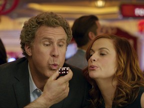 This image released by Warner Bros Pictures shows Will Ferrell, left, and Amy Poehler in a scene from, "The House." The film opened with just $8.7 million, the latest in an increasingly long line of comedy flops at the box office. (Warner Bros. Entertainment via AP)
