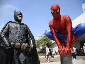 FILE - In this July 23, 2016 file photo, Dorian Black, left, dressed as Batman and Kyle Blankenfield, dressed as Spider-Man appear outside during Comic-Con International in San Diego. The annual pop-culture celebration kicks off Wednesday night with a preview of the San Diego Convention Center's showroom floor. Four days of panels, presentations, screenings and autograph signings begin on Thursday. (Photo by Al Powers/Invision/AP, File)
