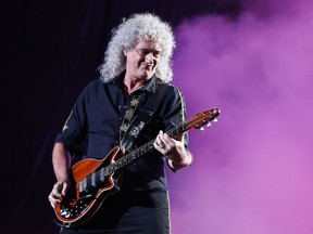 FILE - In this Sept. 19, 2015 file photo, Brian May of the Queen + Adam Lambert performs at the Rock in Rio music festival in Rio de Janeiro, Brazil. May announced Wednesday that he will publish the coffee-table book, "Queen in 3-D," under his own imprint in August. It includes more than 300 photos capturing the rock band's history and a 3-D viewer May designed. (AP Photo/Felipe Dana, File)