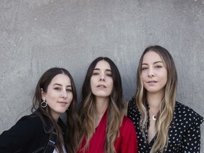 In this June 27, 2017 photo, Alana Haim, from left, Danielle Haim and Este Haim of Haim pose for a portrait  in New York to promote their latest album, "Something to Tell You." (Photo by Taylor Jewell/Invision/AP)