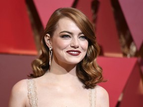FILE - In this Feb. 26, 2017 file photo, actress Emma Stone arrives at the Oscars in Los Angeles. Stone says that male co-stars have taken pay cuts to ensure she received equal pay on films. Speaking to tennis great Billie Jean King in an interview published Thursday, July 6, in Out Magazine, Stone said the gesture to match has impacted what she's able to ask for in the future. (Photo by Richard Shotwell/Invision/AP, File)