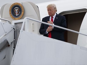 President Donald Trump steps off Air Force One after arriving at Long Island MacArthur Airport in Ronkonkoma, N.Y., Friday, July 28, 2017, to deliver a speech on the street gang MS-13.   (AP Photo/Evan Vucci)