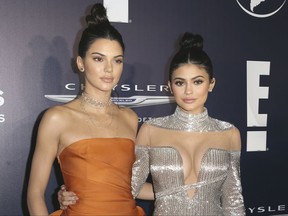 FILE - In this Jan. 8, 2017, file photo, Kendall Jenner, left, and Kylie Jenner arrive at the NBCUniversal Golden Globes afterparty in Beverly Hills, Calif. The Jenner sisters' fashion label, Kendall + Kylie, said Sunday, July 9, that it sold only two "vintage" T-shirts with the late rapper Tupac Shakur's likeness on them before pulling the shirts from the marketplace. The statement came in response to a photographer's lawsuit accusing the Jenners of copyright infringement for using two of his photos for the shirts, which briefly sold for $125 apiece. (Photo by Rich Fury/Invision/AP, File)
