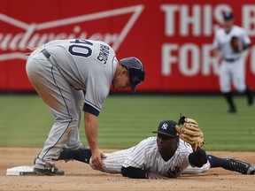 New York Yankees shortstop Didi Gregorius hangs on to the ball and keeps his foot on the bag for the force out at second base on Tampa Bay Rays' Wilson Ramos (40) during the ninth inning of a baseball game, Saturday, July 29, 2017, in New York. The Yankees won 5-4. (AP Photo/Julie Jacobson)