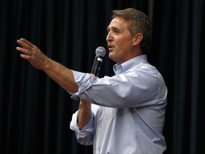 FILE- In this April 13, 2017, file photo, Arizona Republican Sen. Jeff Flake takes a question from the audience during a town hall in Mesa, Ariz. The debut of Flake's book "Conscience of a Conservative" goes on sale on Tuesday, Aug. 1. (AP Photo/Ross D. Franklin, File)