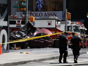 FILE- In this May 18, 2017, file photo, a smashed car sits on the corner of Broadway and 45th Street in New York's Times Square after several were injured when the car was driven into a crowd of pedestrians. Richard Rojas, who is accused of mowing down a crowd of Times Square pedestrians with his car, is scheduled to be in court Thursday, July 13, where he is expected to enter a plea. (AP Photo/Seth Wenig, File)