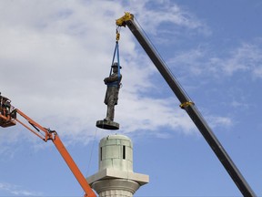 A statue of Confederate General Robert E. Lee is removed from Lee Circle in New Orleans.