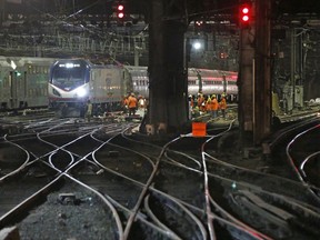 Amtrak workers continue ongoing infrastructure renewal work on the tracks beneath Penn Station, Sunday, July 9, 2017, in New York. A massive two-month repair project will launch Monday at the country's busiest train station. The summer's accelerated repair work, prompted by two derailments this spring, will close some of the station's 21 tracks and require a roughly 20 percent reduction in the number of commuter trains coming in from New Jersey and Long Island. (AP Photo/Kathy Willens)