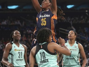 Connecticut Sun forward Jonquel Jones (35) goes to the basket past New York Liberty center Tina Charles (31), guard Epiphanny Prince (10) and center Kia Vaughn (7) during the first half of a WNBA basketball game, Wednesday, July 19, 2017,  at Madison Square Garden in New York. (AP Photo/Mary Altaffer)