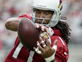 FILE - This July 22, 2017 file photo shows Arizona Cardinals wide receiver Larry Fitzgerald running drills during the first day of NFL football training camp in Glendale, Ariz. Fitzgerald is still producing at a high level as his career winds down, but hasn't yet decided when he will retire. (AP Photo/Matt York, file)