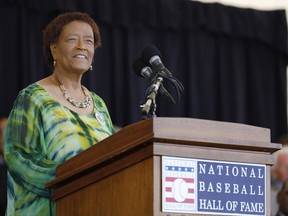 In this photo provided by the National Baseball Hall of Fame and Museum, former sportswriter Claire Smith speaks from the podium during her induction Saturday, July 29, 2017,to the National Baseball Hall of Fame in Cooperstown, N.Y. Smith is the first woman to win the J.G. Taylor Spink Award for meritorious contributions to baseball writing. (Milo Stewart Jr./National Baseball Hall of Fame and Museum via AP)