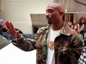 FILE- In this Sept. 4, 1996 file photo, Rapper Tupac Shakur arrives at New York's Radio City Music Hall for the 13th Annual MTV Video Music Awards. A New York judge has stopped on Tuesday, July 18, 2017, an impending auction of pop star Madonna's personal items, including a love letter from Shakur, her former boyfriend. (AP Photo/Todd Plitt, File)