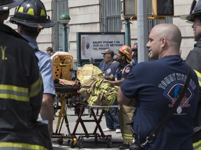 FILE- In this June 27, 2017 file photo, emergency service personnel work at the scene of a subway train derailment in the Harlem neighborhood of New York. Transit in and around New York City has been plagued by a series of derailments, delays and breakdowns, with the latest one coming on Friday, July 21 with the derailment of a "B" line train at Brighton Beach in the Brooklyn borough of New York. (AP Photo/Mary Altaffer, File)