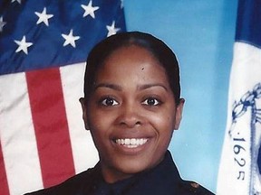 This undated photo provided by the New York Police Department shows officer Miosotis Familia, who was shot to death early Wednesday, July 5, 2017, ambushed inside a command post RV by an ex-convict, authorities said. The gunman was killed by police about a block away. (NYPD via AP)