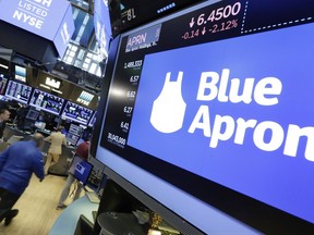 The Blue Apron logo appears above a trading post on the floor of the New York Stock Exchange, Tuesday, July 18, 2017. The meal kit company tumbled after The Sunday Times reported that Amazon is getting ready to launch its own meal-prep business. (AP Photo/Richard Drew)