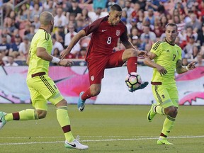 FILE - In this Saturday, June 3, 2017, file photo, United States forward Clint Dempsey (8) controls the ball as Venezuela's Jose Manuel Velazquez, left, and Pablo Camacho (17) defend in the first half during an international friendly match  in Sandy, Utah. On Sunday, July 16, 2017, the U.S. Soccer Federation announced that Dempsey, midfielder Michael Bradley and goalkeeper Tim Howard are among six additions to the U.S. roster for the knockout phase of the CONCACAF Gold Cup. U.S. coach Bruce Arena also added forward Jozy Altidore, midfielder Darlington Nagbe and goalkeeper Jesse Gonzalez. (AP Photo/Rick Bowmer, File)