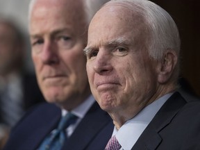 FILE - In a Tuesday, June 13, 2017 file photo, Sen. John McCain, R-Ariz., right, with Sen. John Cornyn, R-Texas, listens as Attorney General Jeff Sessions testifies on Capitol Hill in Washington. The Philadelphia museum announced Thursday, July 6, 2017, that McCain  has been named this year's recipient of the National Constitution Center's Liberty Medal for his "lifetime of sacrifice and service" to the country. (AP Photo/J. Scott Applewhite, File)