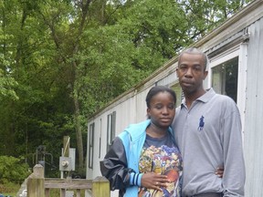 FILE - In this April 12, 2016 file photo, Lakeya Hicks and Elijah Pontoon stand outside their home in Aiken, South Carolina. The couple has settled a lawsuit filed after they accused police of subjecting them to illegal body searches. Documents filed in federal court show Lakeya Hicks and Elijah Pontoon stipulated to the dismissal of their lawsuit against police officers for the City of Aiken. (AP Photo/Meg Kinnard, File)