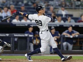 New York Yankees Aaron Judge watches his fifth-inning solo home run in the team's baseball game against the Milwaukee Brewers in New York, Friday, July 7, 2017. (AP Photo/Kathy Willens)