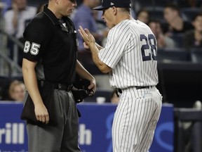 New York Yankees manager Joe Girardi argues a call with umpire Stu Scheurwater during the seventh inning of the team's baseball game against the Tampa Bay Rays on Thursday, July 27, 2017, in New York. (AP Photo/Frank Franklin II)