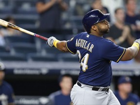 Milwaukee Brewers' Jesus Aguilar watches his grand slam against the New York Yankees during the seventh inning of a baseball game in New York, Friday, July 7, 2017. (AP Photo/Kathy Willens)
