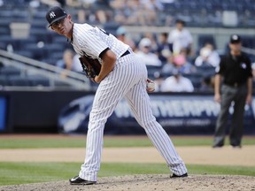 FILE - In this June 24, 2017, file photo, New York Yankees relief pitcher Tyler Clippard checks the runner on first base during the team's baseball game against the Texas Rangers in New York. The Yankees made an early push for playoff run Tuesday night, July 18, acquiring infielder Todd Frazier and relievers David Robertson and Tommy Kahnle from the Chicago White Sox for Clippard and three prospects. (AP Photo/Frank Franklin II, File)