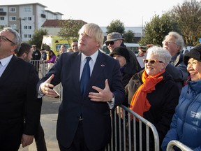 British Foreign Secretary Boris Johnson, center, gestures as he speaks with guests as Foreign Minister Gerry Brownlee, left, watches during the service at Pukeahu National War Memorial Park in Wellington, New Zealand, Monday, July 24, 2017. Johnson is visiting the South Pacific nation for two days as Britain looks to strengthen its ties with its former colony amid a broader reshaping of Britain's global relationships as it prepares to leave the European Union. (Mark Mitchell/New Zealand herald via AP)