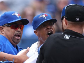 Marcus Stroman is held back during an argument with umpire Will Little on July 27.