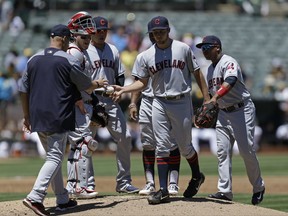 Cleveland Indians' Trevor Bauer, center, hands the ball to manager Terry Francona, left, as he is removed in the first inning of a baseball game against the Oakland Athletics, Sunday, July 16, 2017, in Oakland, Calif. (AP Photo/Ben Margot)