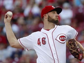 Cincinnati Reds starting pitcher Tim Adleman throws during the first inning of the team's baseball game against the Washington Nationals, Friday, July 14, 2017, in Cincinnati. (AP Photo/John Minchillo)