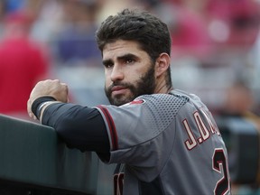 Arizona Diamondbacks right fielder J.D. Martinez stands in the dugout in the first inning of a baseball game against the Cincinnati Reds, Wednesday, July 19, 2017, in Cincinnati. (AP Photo/John Minchillo)