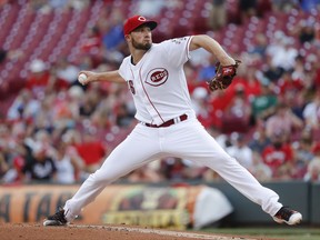 Cincinnati Reds starting pitcher Tim Adleman throws in the first inning of a baseball game against the Arizona Diamondbacks, Wednesday, July 19, 2017, in Cincinnati. (AP Photo/John Minchillo)