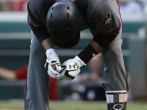 Arizona Diamondbacks' J.D. Martinez doubles over in pain after being struck while swinging at a pitch from Cincinnati Reds starting pitcher Tim Adleman in the fourth inning of a baseball game, Wednesday, July 19, 2017, in Cincinnati. (AP Photo/John Minchillo)