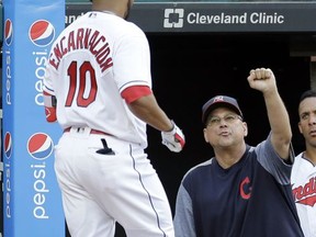 Cleveland Indians manager Terry Francona, right, congratulates Edwin Encarnacion after Encarnacion hit a solo home run off Toronto Blue Jays starting pitcher Marco Estrada during the second inning of a baseball game, Friday, July 21, 2017, in Cleveland. (AP Photo/Tony Dejak)