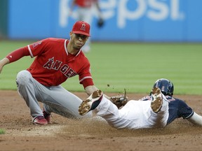 Los Angeles Angels' Andrelton Simmons, left, tags out Cleveland Indians' Erik Gonzalez on a steal to second base in the third inning of a baseball game, Wednesday, July 26, 2017, in Cleveland. (AP Photo/Tony Dejak)