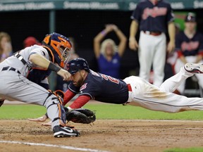 Cleveland Indians' Jason Kipnis dives into home plate to score as Detroit Tigers catcher Alex Avila waits for the ball during the seventh inning of a baseball game, Friday, July 7, 2017, in Cleveland. (AP Photo/Tony Dejak)
