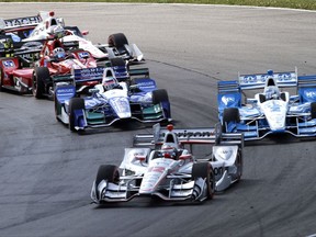 Will Power, of Australia, leads the field through the first corner after the green flag at the IndyCar Honda Indy 200 auto race Sunday, July 30, 2017, at Mid-Ohio Sports Car Course in Lexington, Ohio. (AP Photo/Tom E. Puskar)