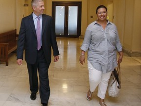 Newly elected Oklahoma state Sen. Michael Brooks walks with his wife, Jessica Martinez-Brooks, right, during a tour of the state Capitol in Oklahoma City, Wednesday, July 12, 2017. Brooks won his Senate seat in a special election Tuesday, July 11, 2017, held to fill the Senate district 44 seat vacated when Sen. Ralph Shortey resigned. (AP Photo/Sue Ogrocki)