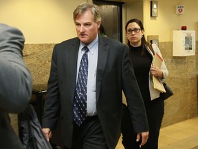 FILE - In this Friday, June 30, 2017 file photo, Shannon Kepler, left, arrives with his legal team for afternoon testimony in his third trial in Tulsa, Okla. Kepler, a former Oklahoma police officer who fatally shot his daughter's black boyfriend in 2014, will face a fourth trial in the shooting death. (AP Photo/Sue Ogrocki, File)