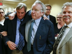 Shannon Kepler celebrates with his attorney, Richard O'Carroll, after a hung jury verdict was announced at the Tulsa Country Courthouse, Friday, July 7, 2017, in Tulsa, Okla. A third mistrial was declared Friday in the murder case of Kepler, a white former Oklahoma police officer accused in the off-duty fatal shooting of his daughter's black boyfriend.  (Ian Maule/Tulsa World via AP)