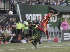 Portland Timbers' Dairon Asprilla (27) and Real Salt Lake's Danny Acosta (25) vie for the ball during an MLS soccer match Wednesday, July 19, 2017, in Portland, Ore. (Sean Meagher/The Oregonian via AP)