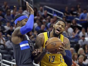 FILE - In this April 8, 2017, file photo, Indiana Pacers' Paul George (13) tries to get position to shoot against Orlando Magic's Terrence Ross during an NBA basketball game in Orlando, Fla. Two people with knowledge of the details say the Pacers have agreed to trade George to the Oklahoma City Thunder for Victor Oladipo and Domantas Sabonis in a stunning deal that gives MVP Russell Westbrook a new running mate. (AP Photo/John Raoux, File)