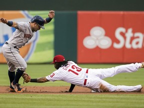 Houston Astros' Jose Altuve, left, tries to get away from a tag by Philadelphia Phillies shortstop Freddy Galvis, right, after he overran second base during the first inning of a baseball game, Monday, July 24, 2017, in Philadelphia. Altuve was out on the play. (AP Photo/Chris Szagola)