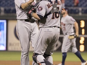 Houston Astros relief pitcher James Hoyt, left, celebrates the win with catcher Brian McCann, right, following the ninth inning of a baseball game, Tuesday, July 25, 2017, in Philadelphia. The Astros won 13-4. (AP Photo/Chris Szagola)