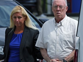 Rev. John T. Sweeney, of Greensburg, Pa., right, arrives for an appearance before District Judge Cheryl J. Peck-Yakopec, in Leechburg, Pa., Monday, July 24, 2017. Pennsylvania Attorney General Josh Shapiro announced that Sweeney was arrested today and charged with involuntary sexual intercourse, a first-degree felony, for a sexual assault committed against a 10-year-old boy. (AP Photo/Gene J. Puskar)